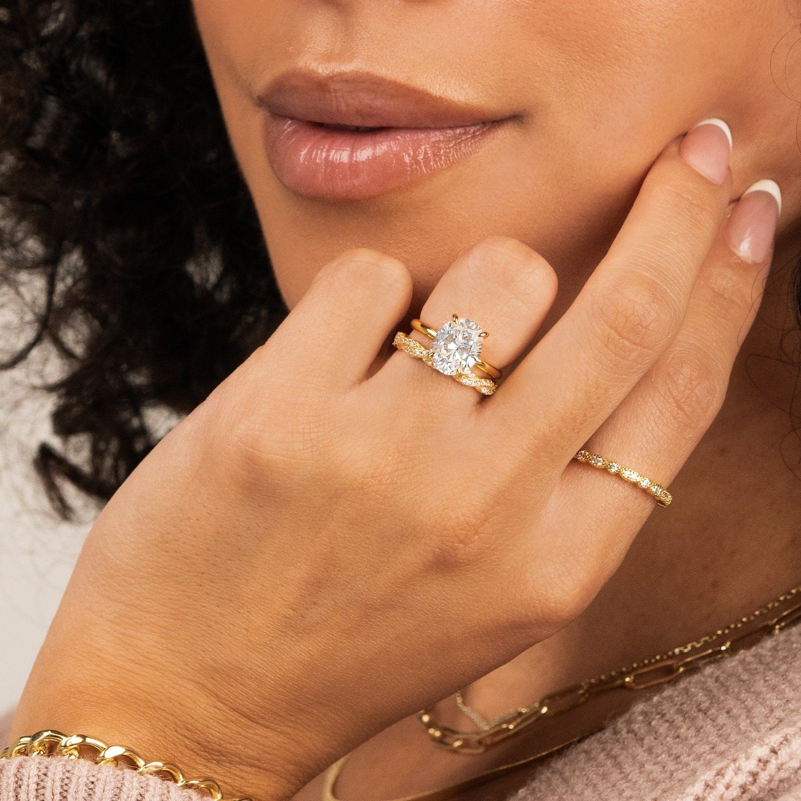woman wearing gold oval shaped engagement ring