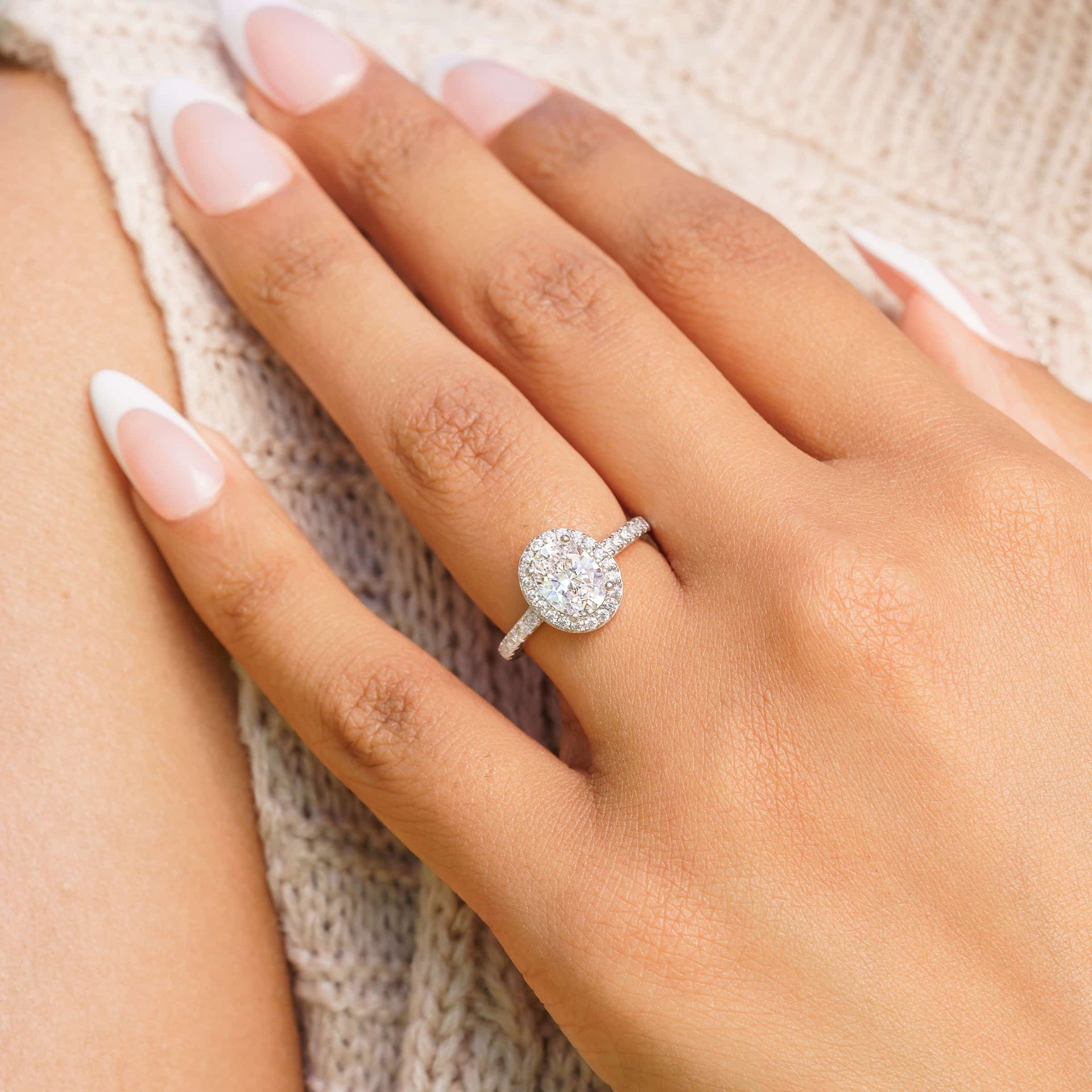woman wearing belle oval shaped engagement ring on hand