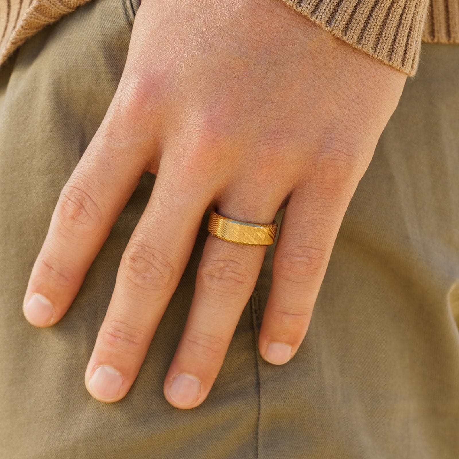 Durable gold men's ring modeled on male hand