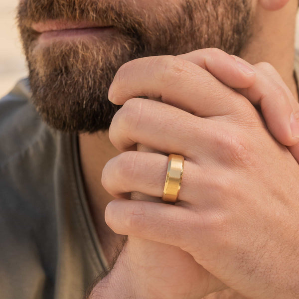 man wearing gold wedding band on finger called the titan