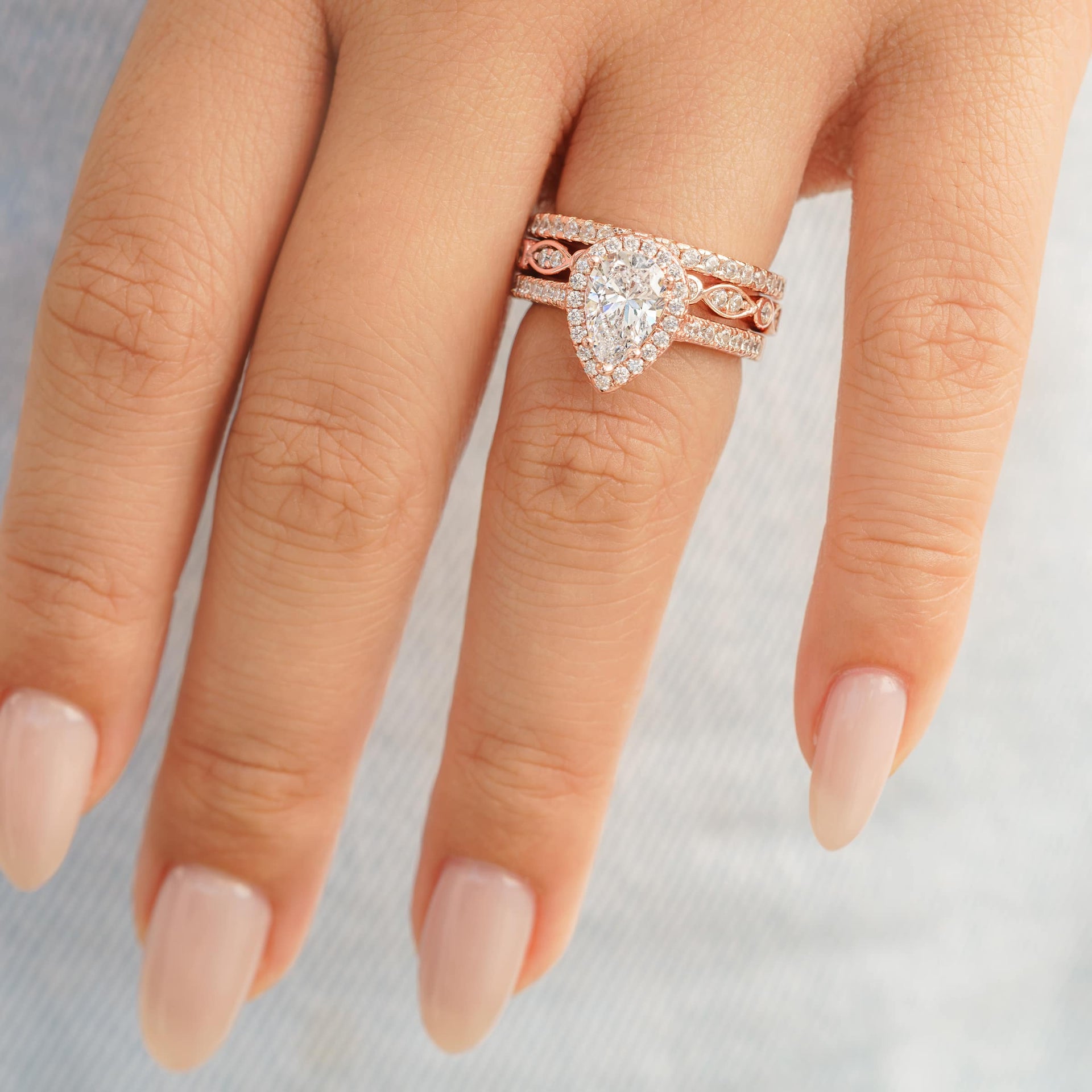 gorgeous rose gold pear shaped engagement ring with wedding bands
