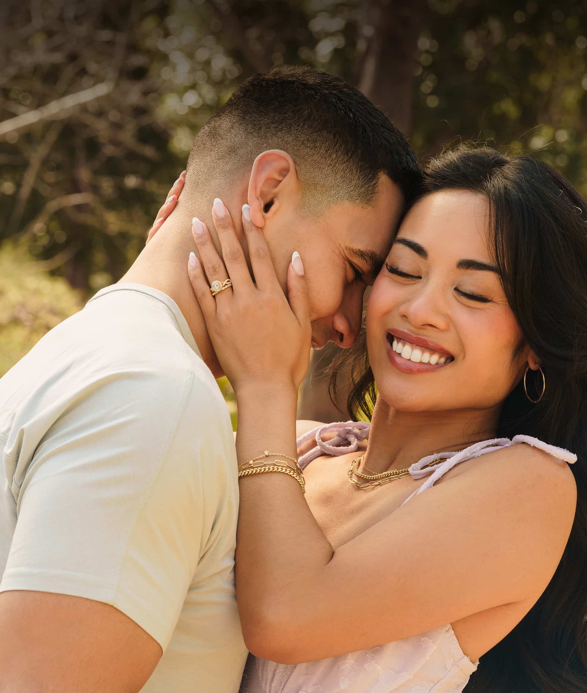 couple hugging with woman wearing vintage gold engagement ring