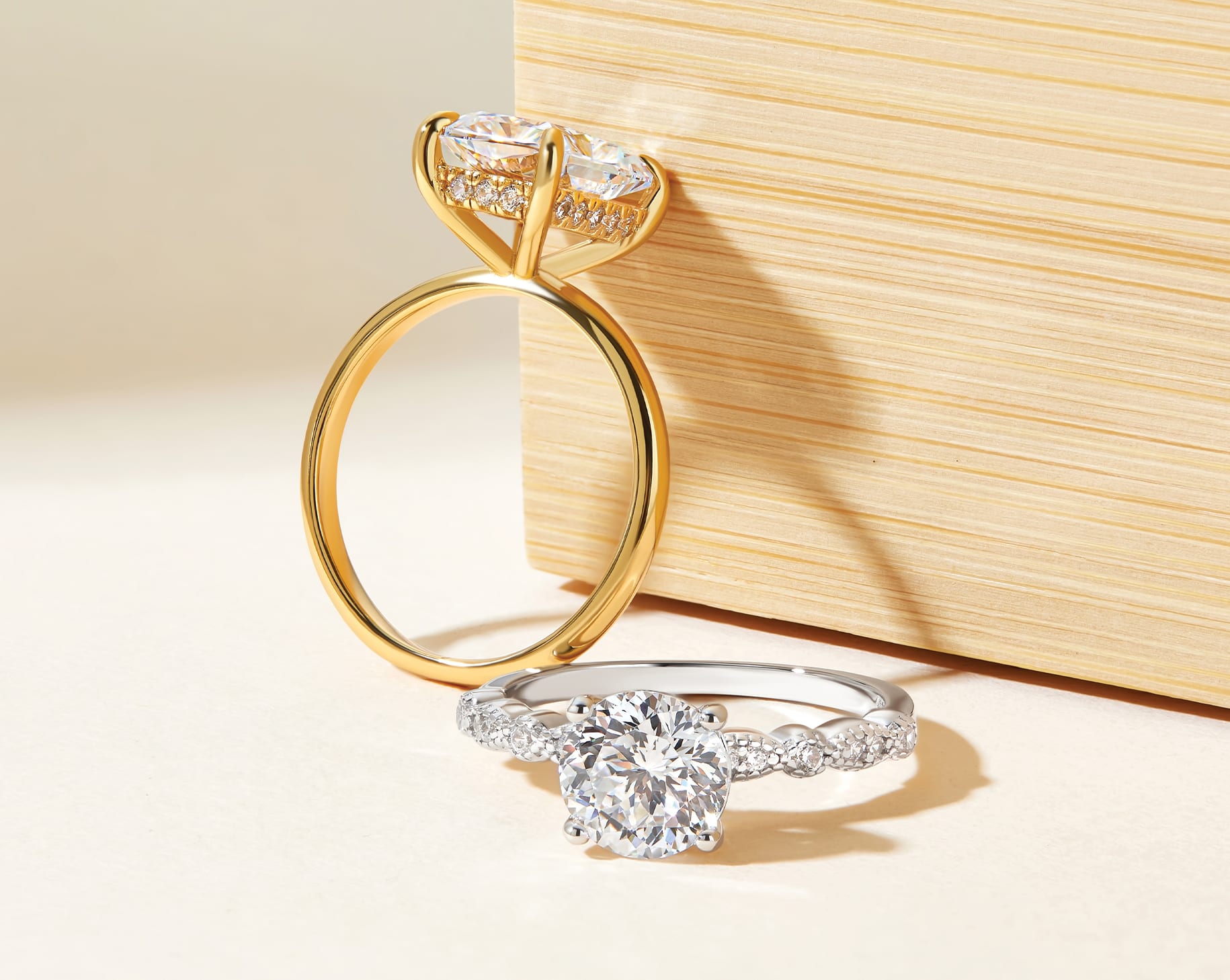 flatlay with gold and silver engagement ring showing hidden halo