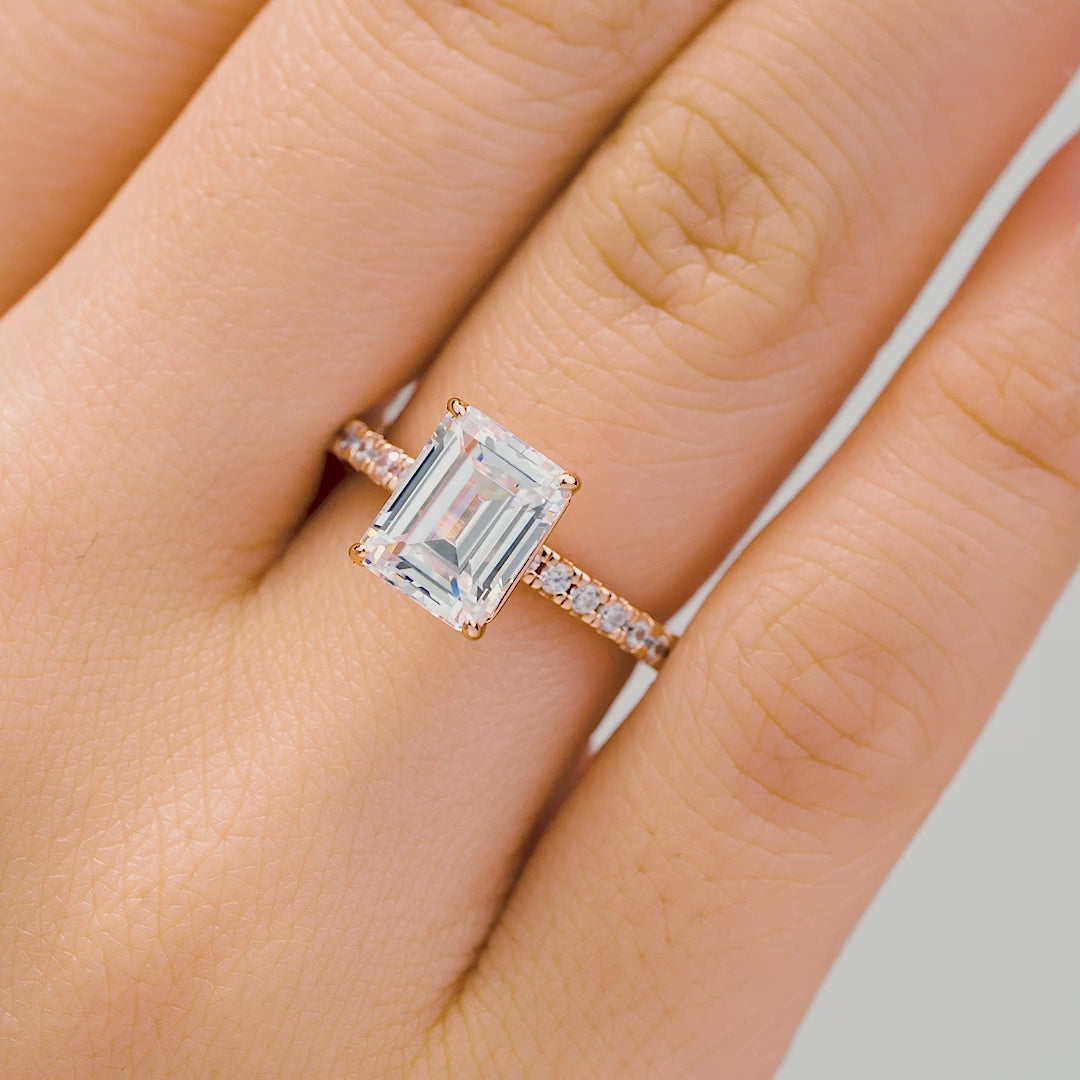 rose gold emerald engagement ring modeled on female hand
