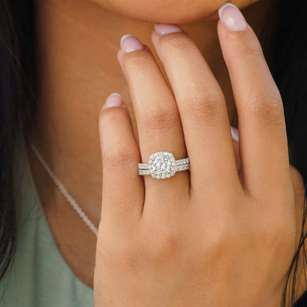 woman wearing silver cushion cut wedding ring set on finger