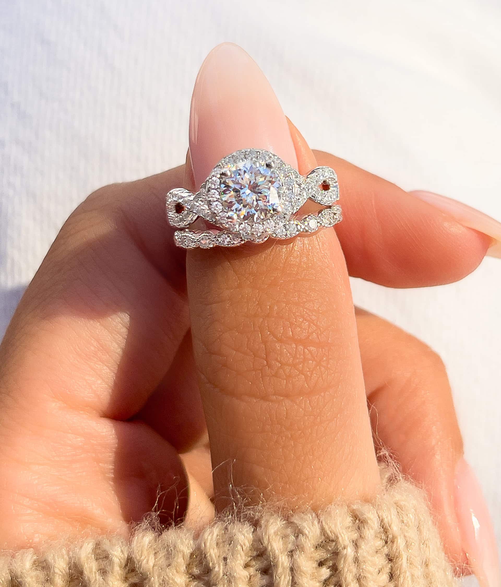 woman pinching silver vintage engagement ring