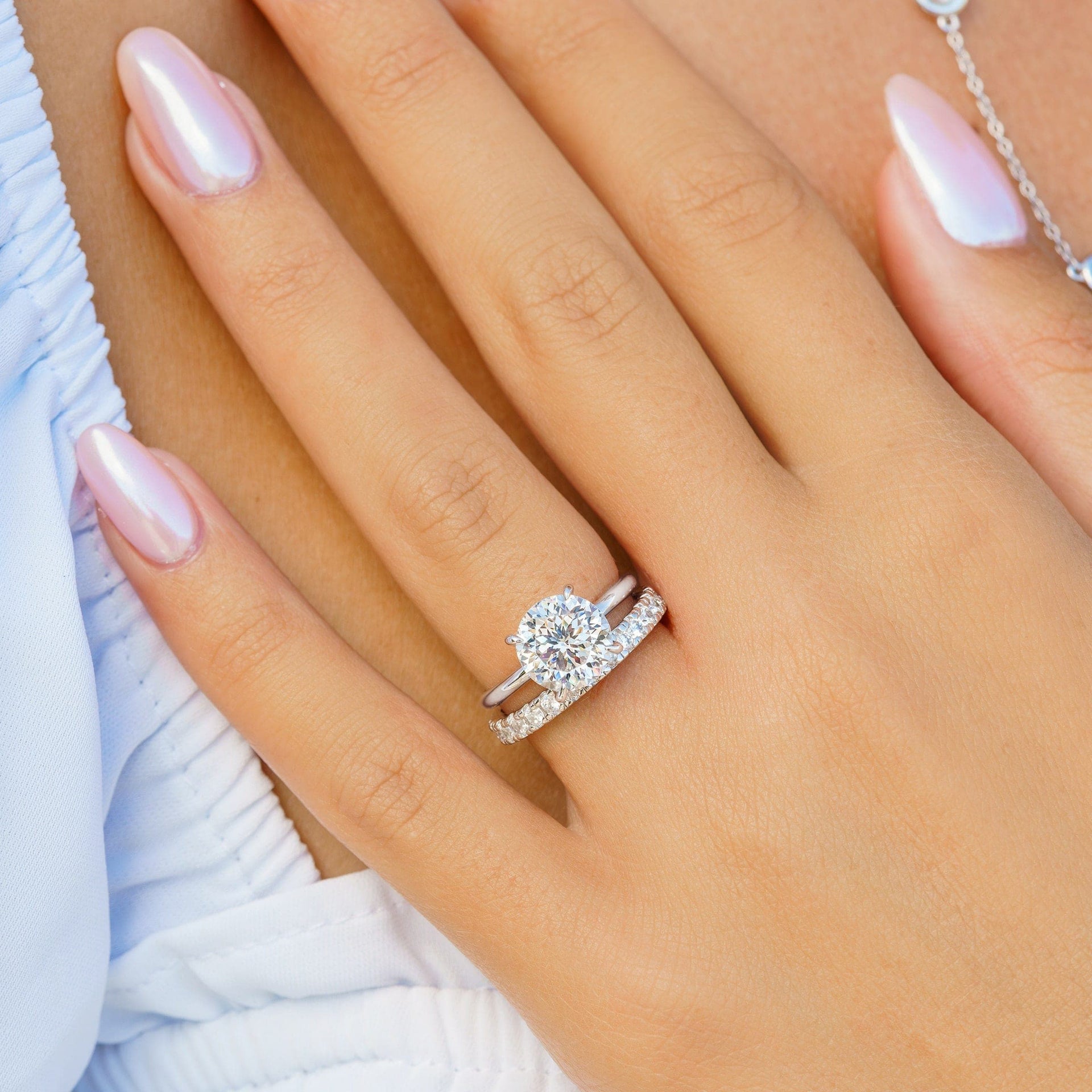 woman wearing silver chelsea engagement ring with eternity band