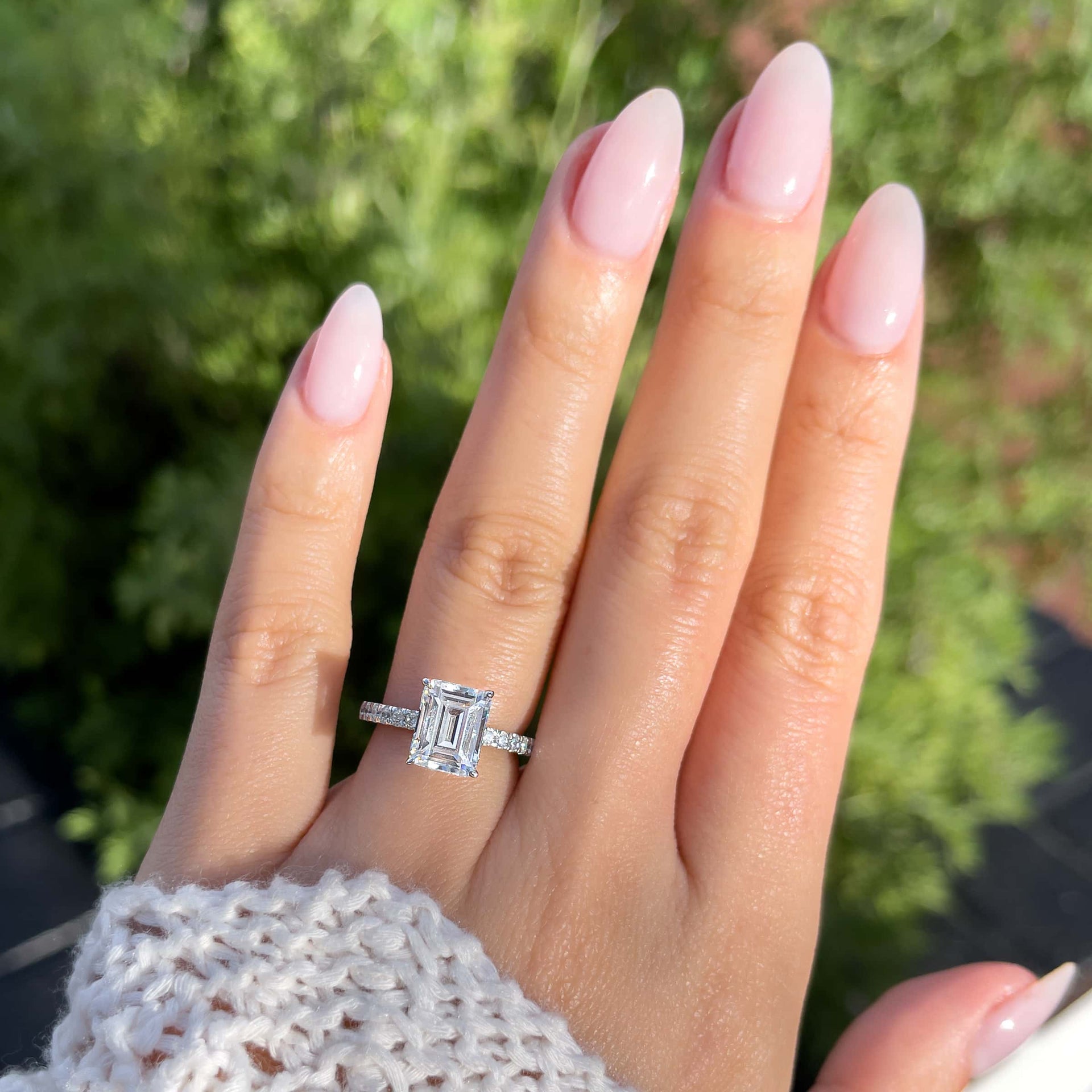 Classic emerald cut engagement ring modeled on female hand