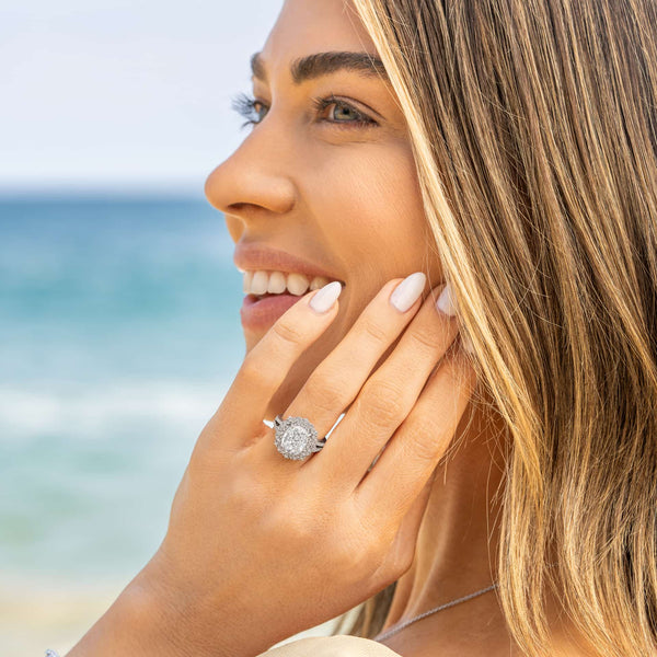 gorgeous vintage engagement ring on woman's hand by ocean