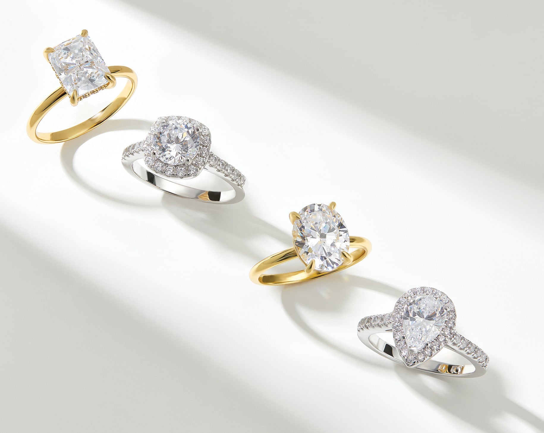 4 engagement rings in gold and silver in a row