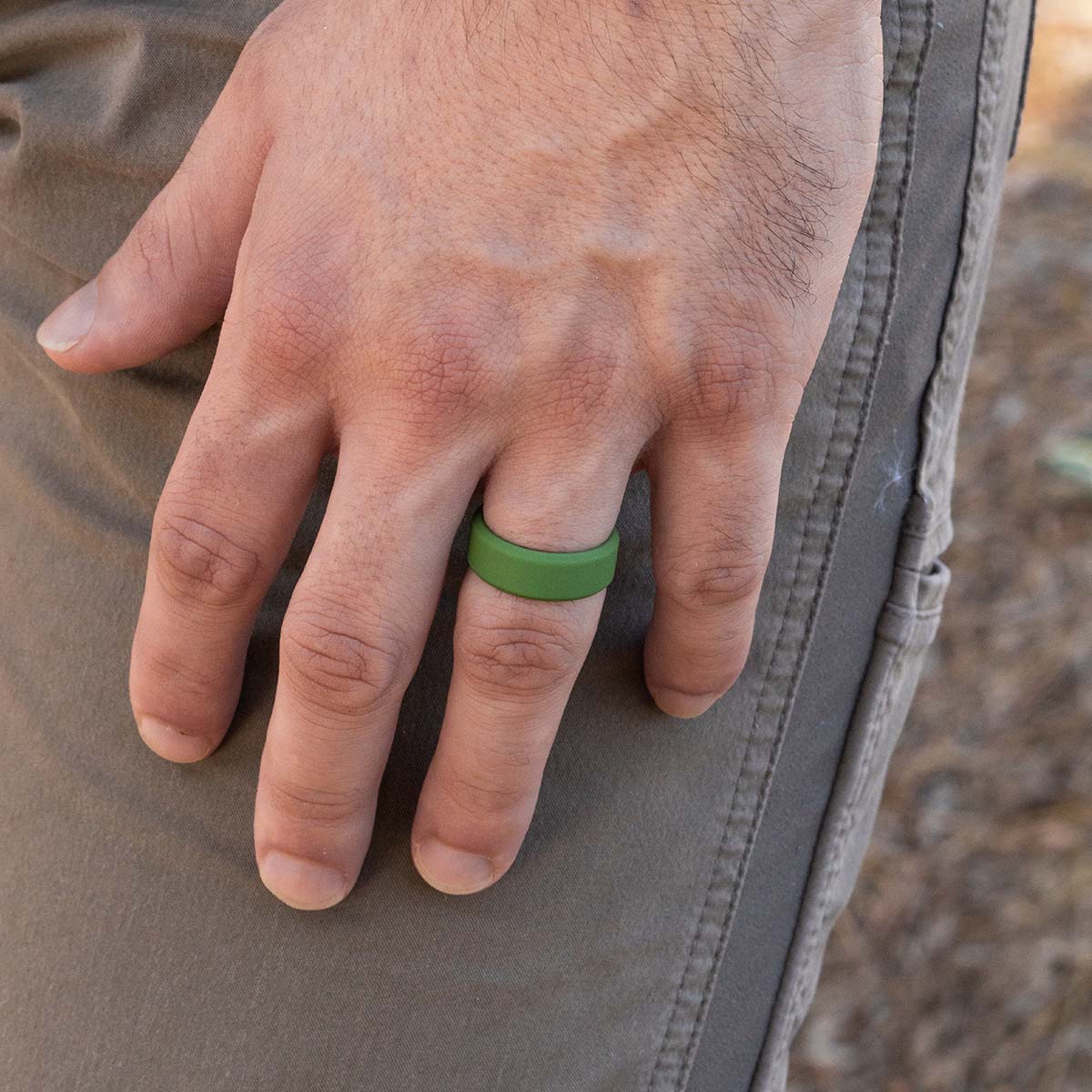 Green rubber ring on a male hand
