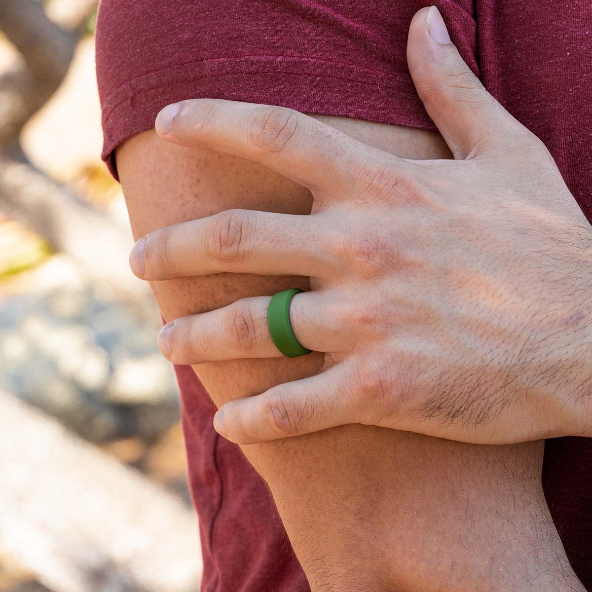 Male hand wearing a versatile green silicone ring