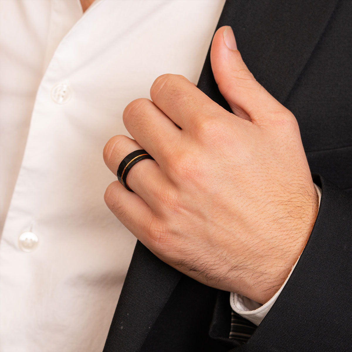 Man wearing black and rose gold tungsten ring