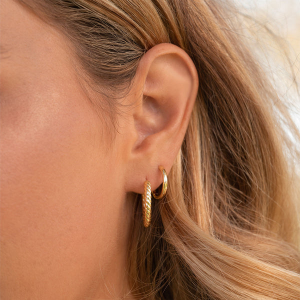 Cute gold earring stack on model