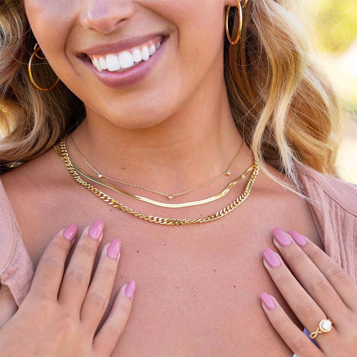 Cute layered gold necklaces on model