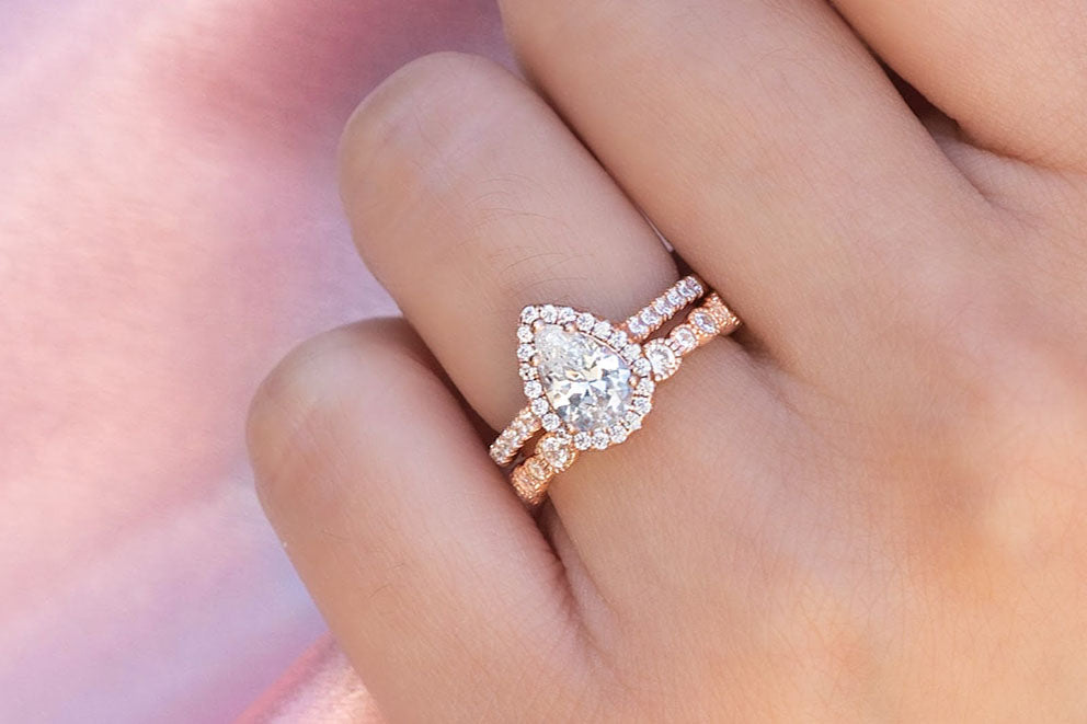 closeup of pear engagement ring set