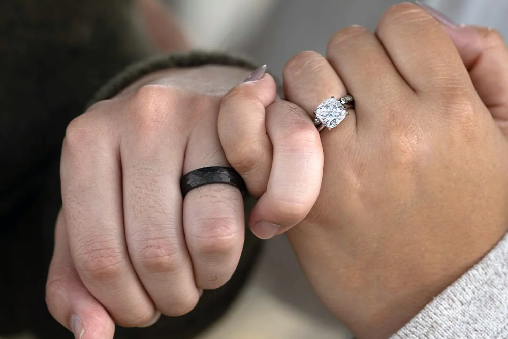 close up of couples wearing engagement rings