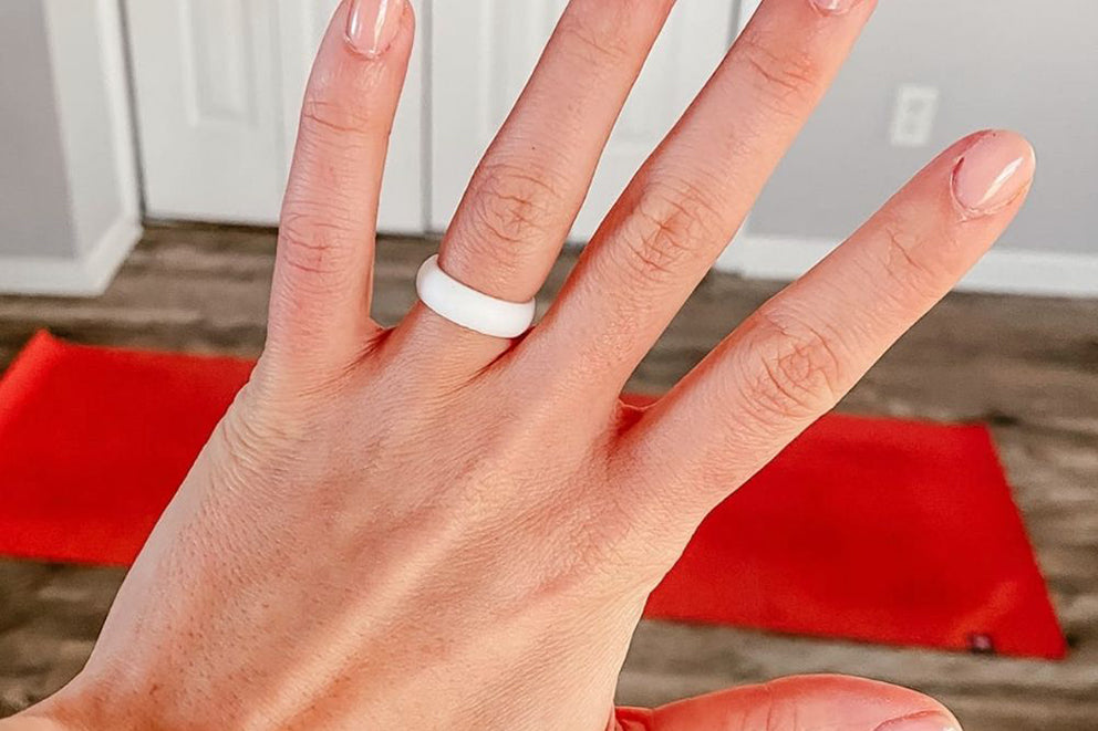 a person wearing the flex wedding band in white