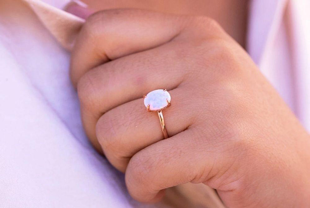 a woman wearing the aurora ring in rose gold