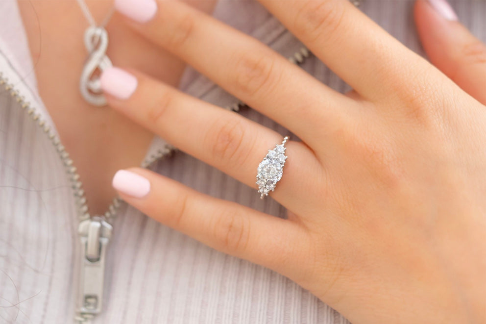 a woman wearing the i do engagement ring