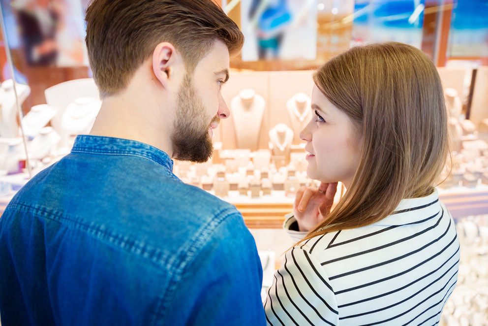 couple discuss while jewelry shopping