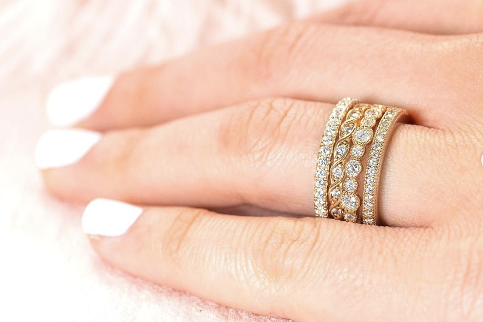 woman with small rings stacked on finger