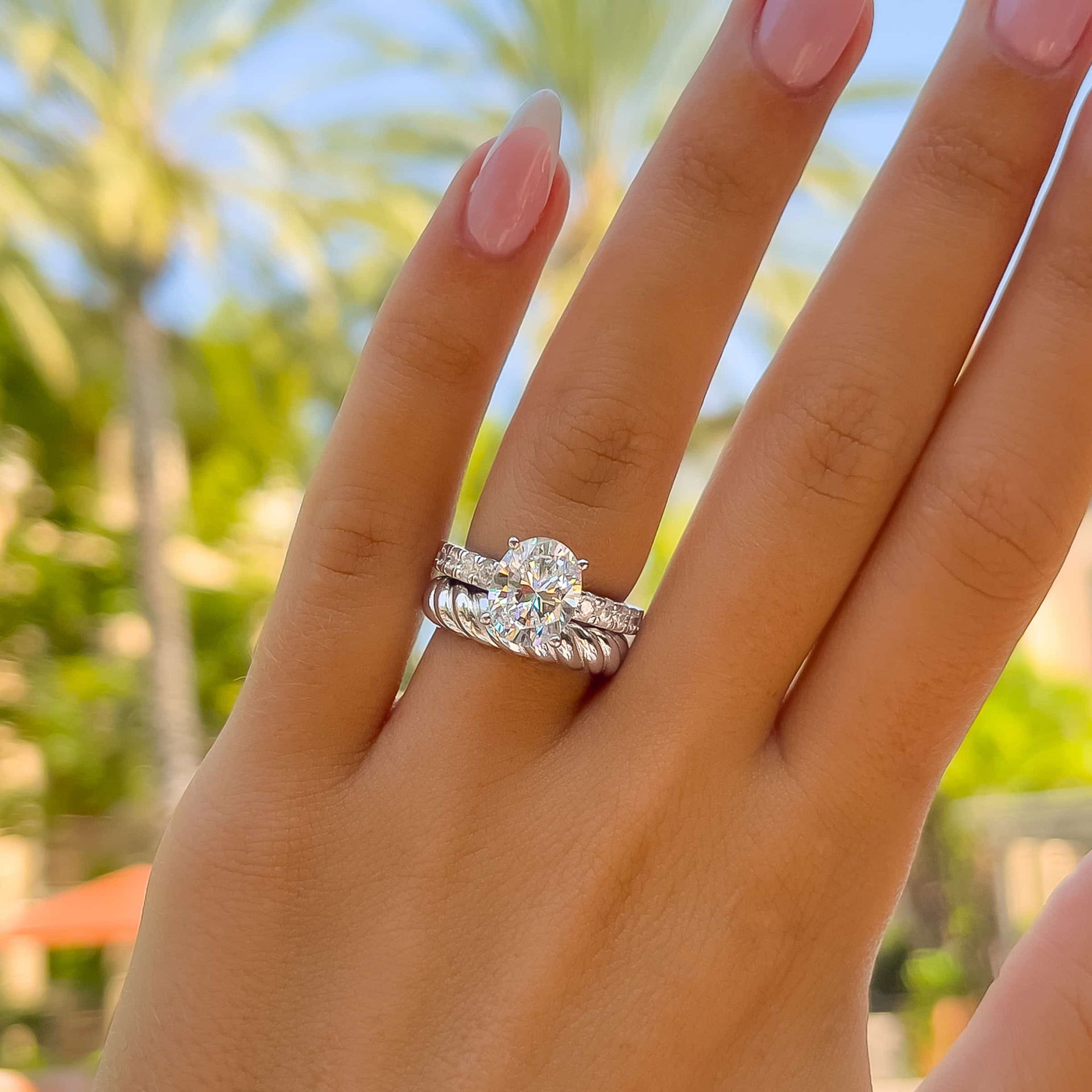 bold silver wedding ring set on model with french tip nails