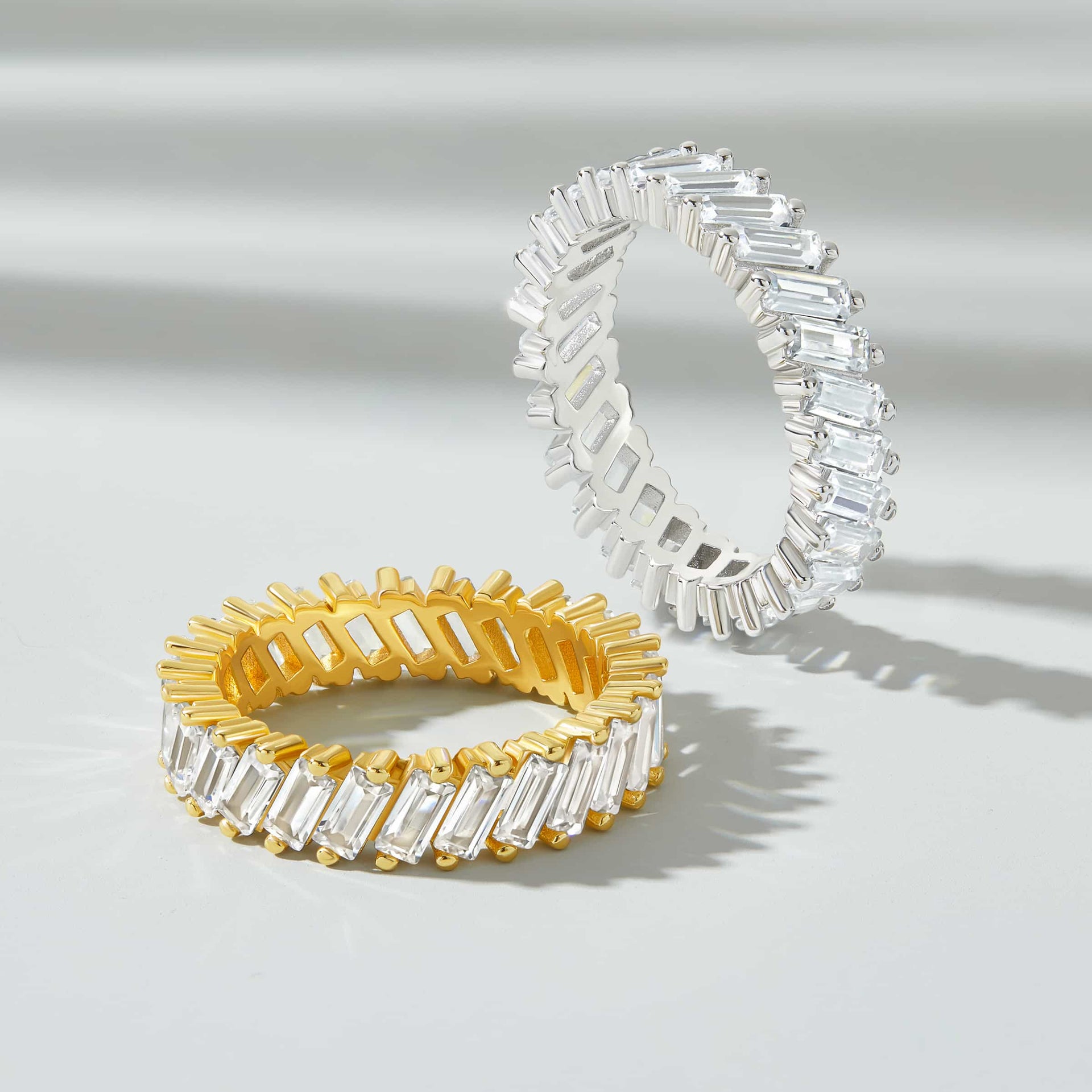 flatlay showing gold and silver artemis wedding band