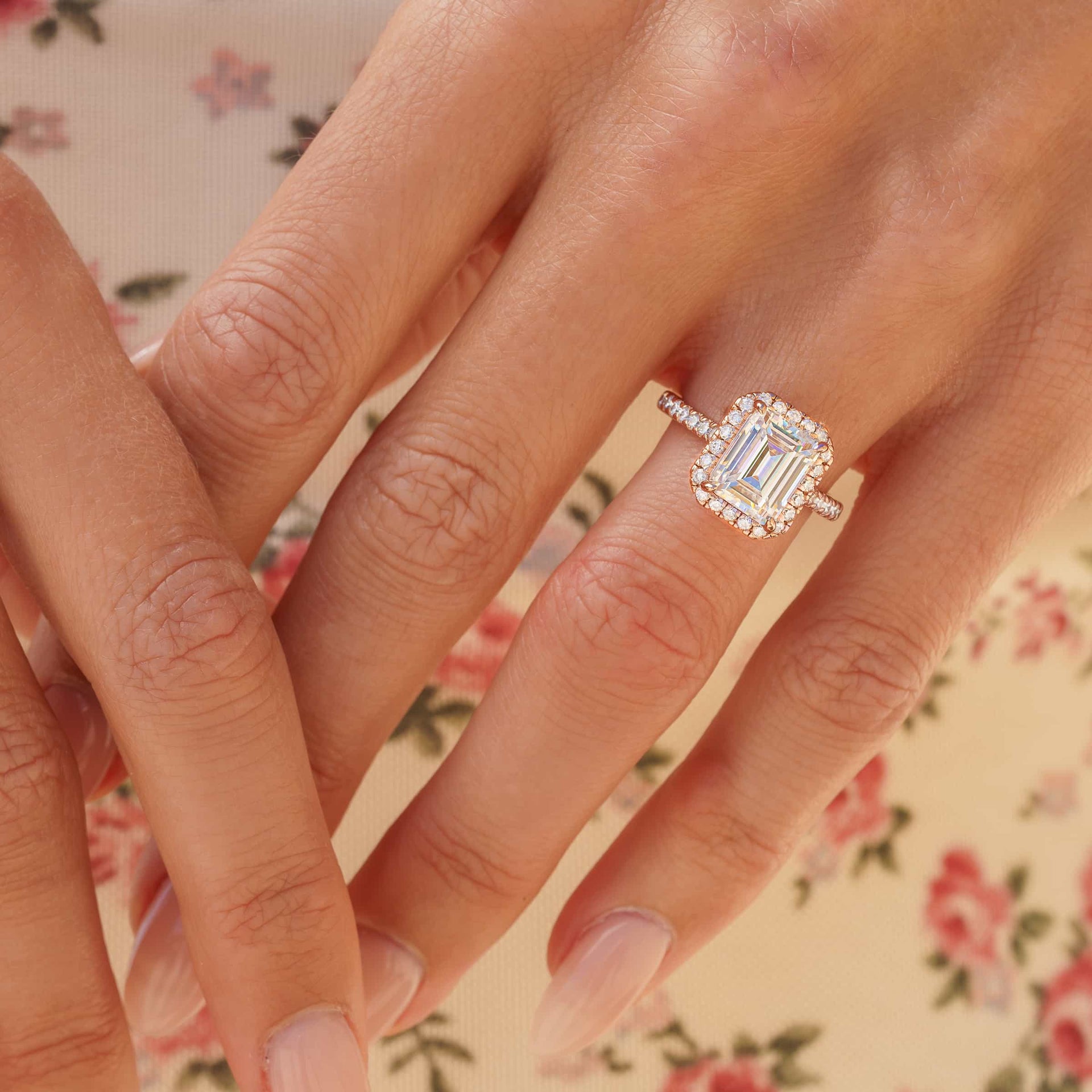 3 carat engagement ring shown in rose gold modeled on female wearing floral top 