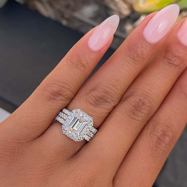 woman wearing stunning emerald cut wedding stack with two desire wedding bands