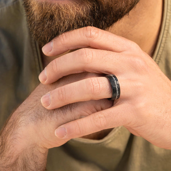man wearing black eclipse wedding ring