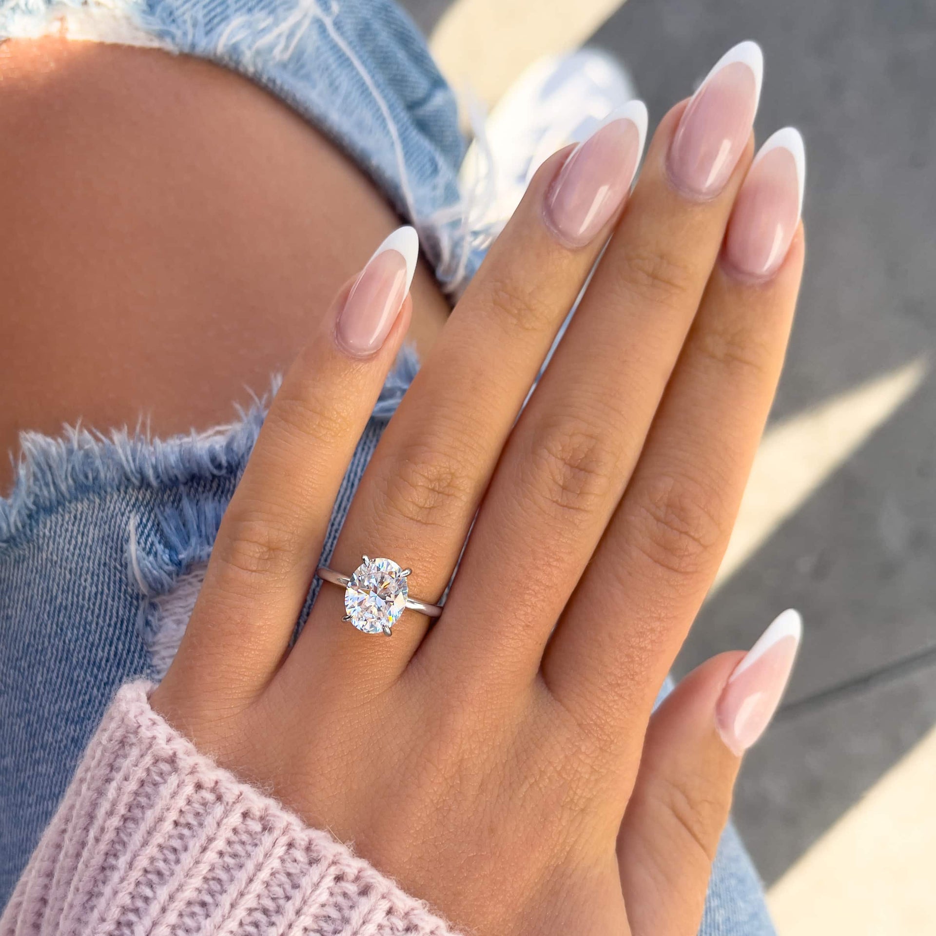 silver oval cut engagement ring on hand