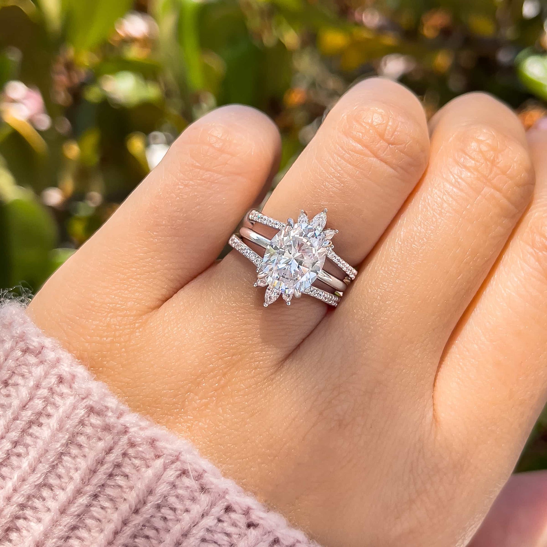 woman wearing oval engagement ring in wedding ring stack with two silver elsa's