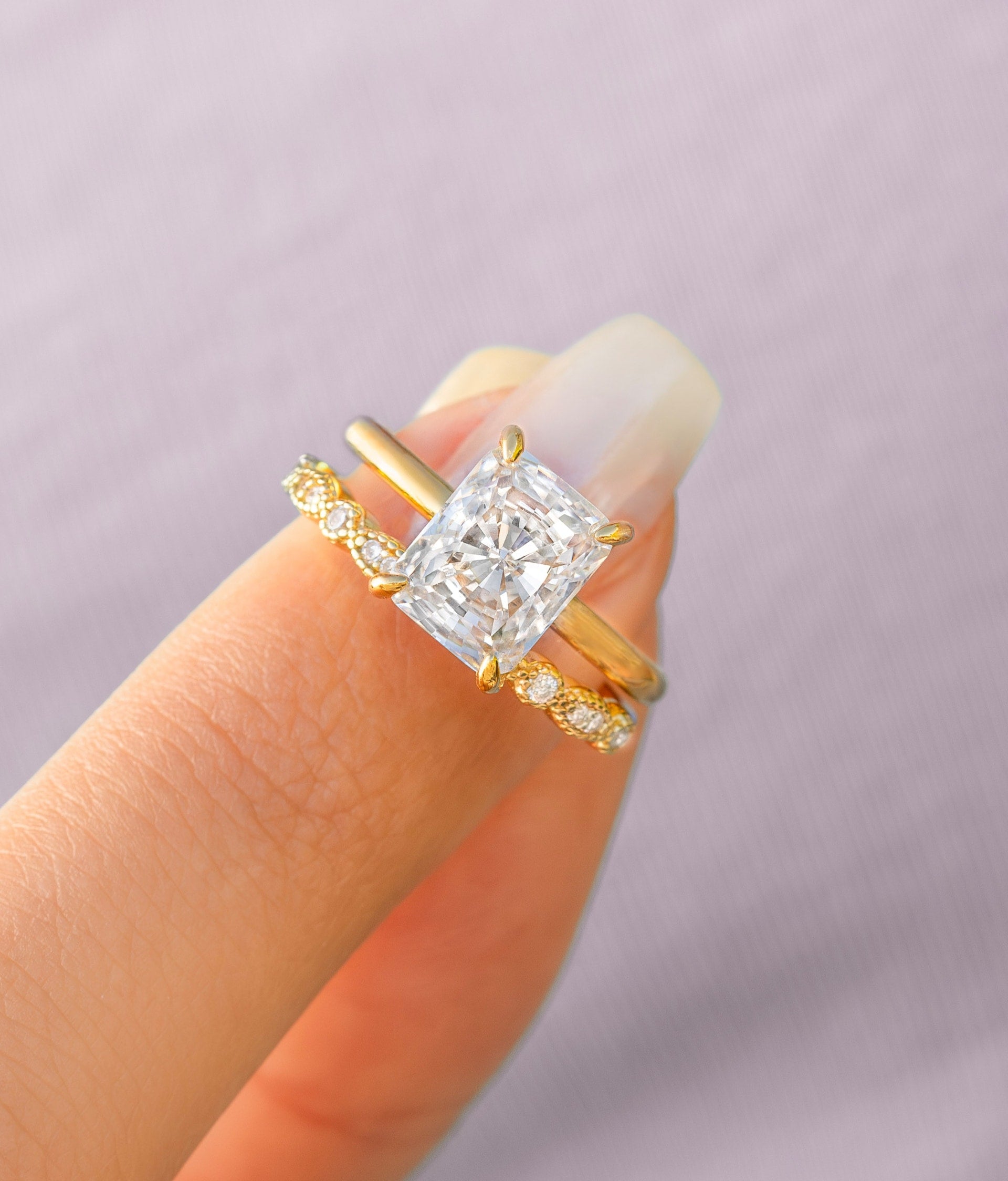 woman pinching gold radiant cut engagement ring