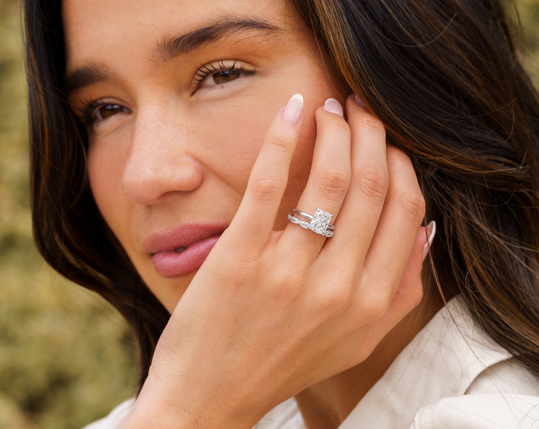 woman wearing silver radiant cut engagement ring