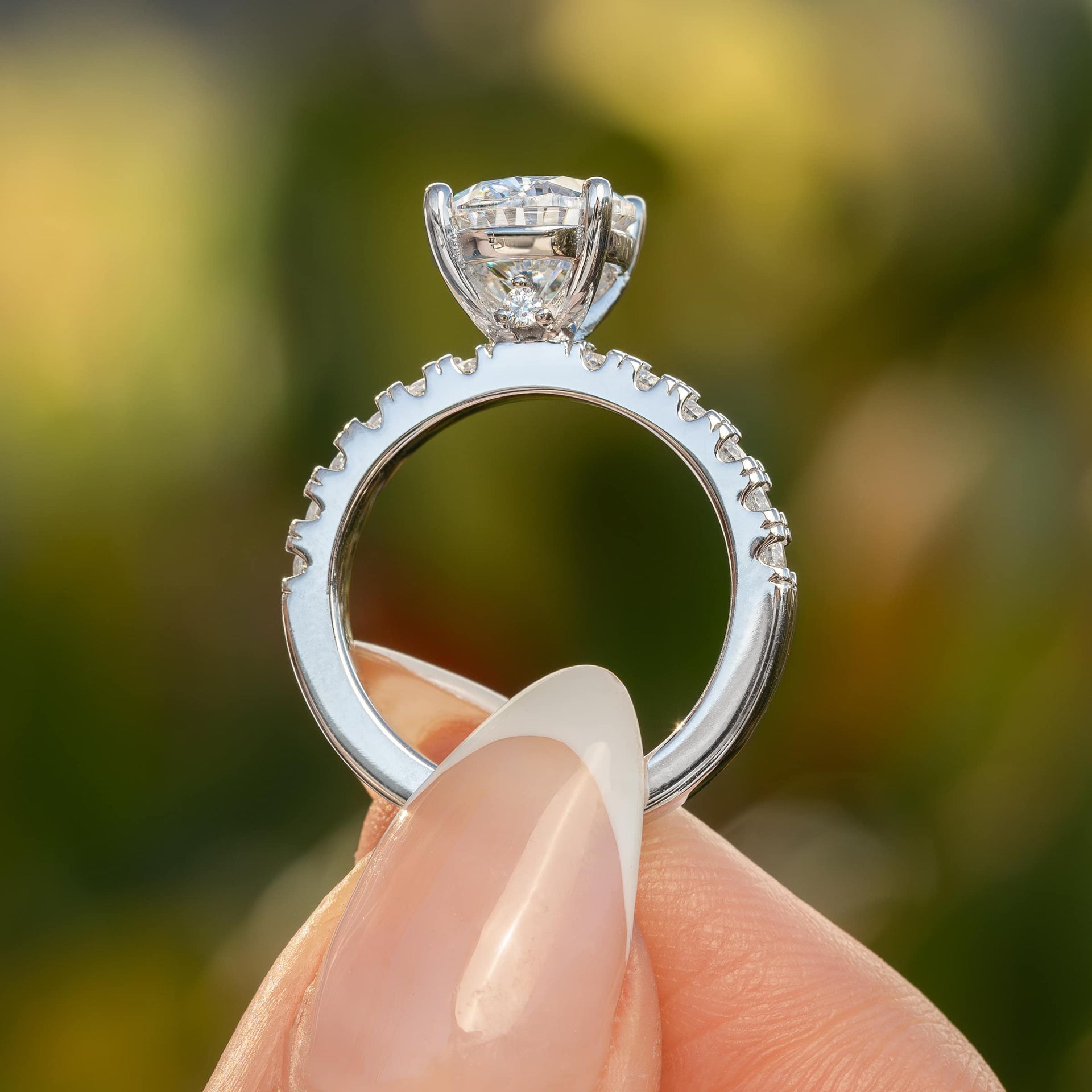 side profile of sleek silver oval cut engagement ring