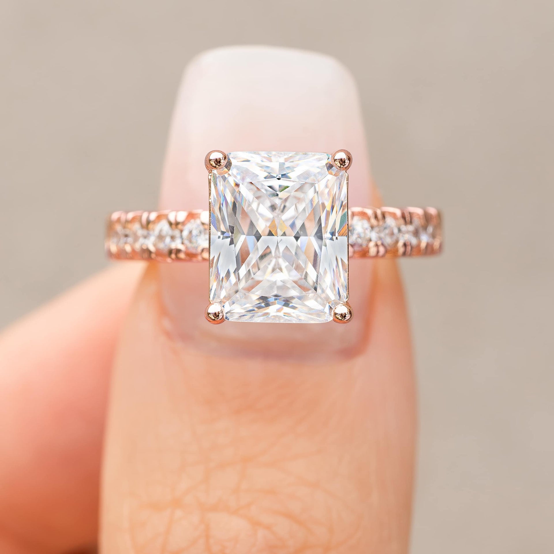 3.75 carat rose gold engagement ring shown in silver modeled on female with light pink nails 
