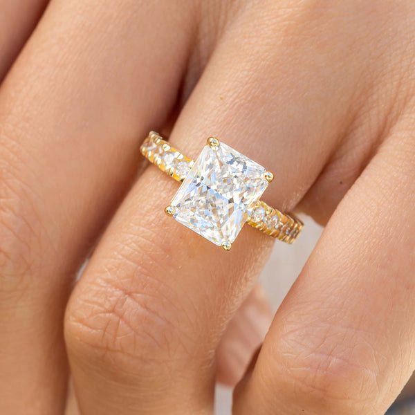 stunning gold radiant cut engagement ring with half eternity band modeled on female hand