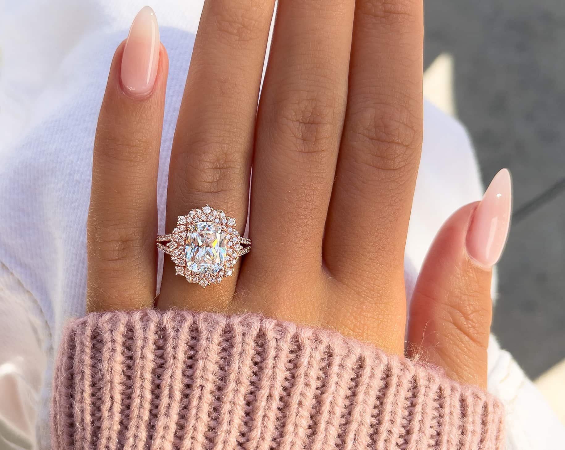gorgeous rose gold vintage engagement ring with pink sweater and white jeans