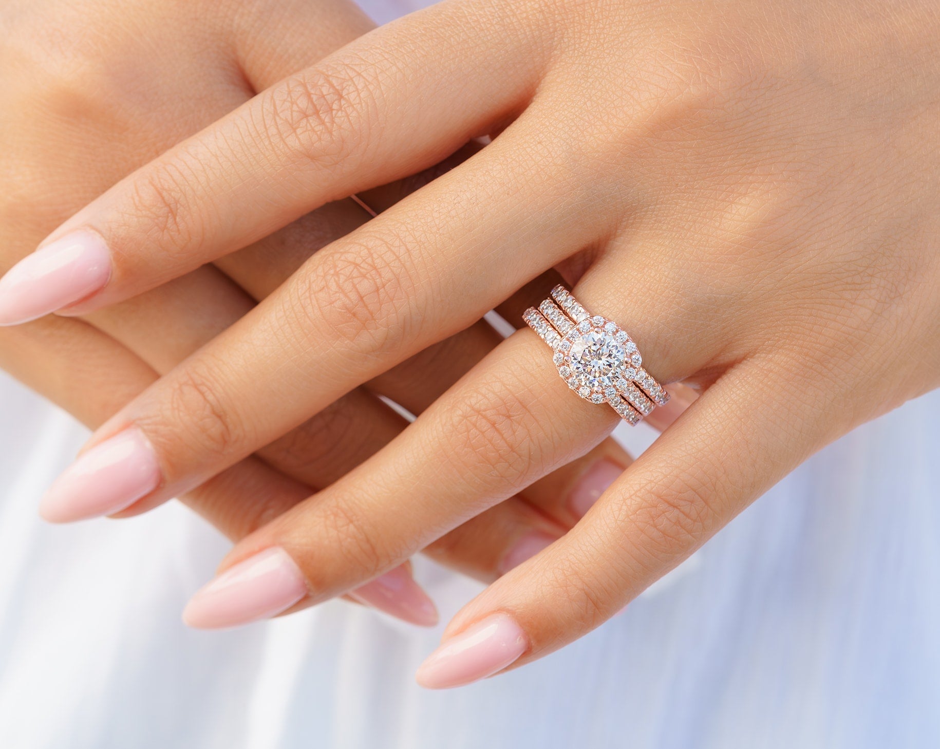 woman wearing rose gold triple stack engagement ring