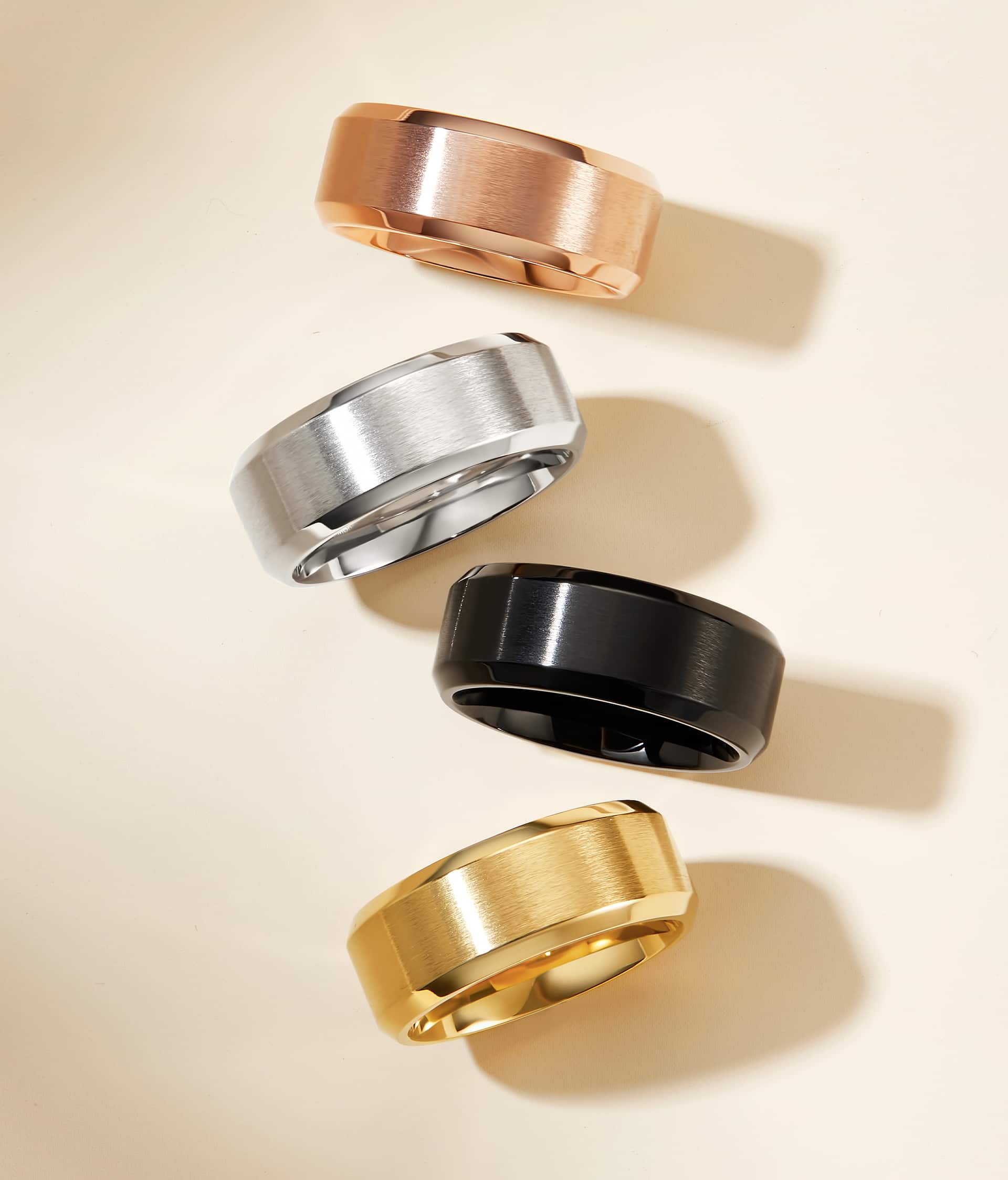 mens bands in rose gold, silver, black, and gold