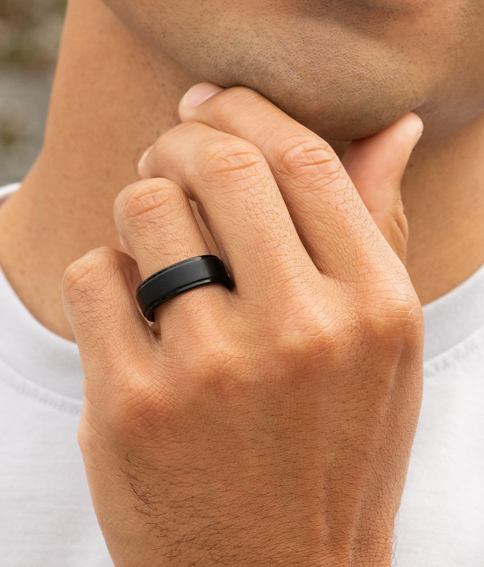 man wearing black wedding ring
