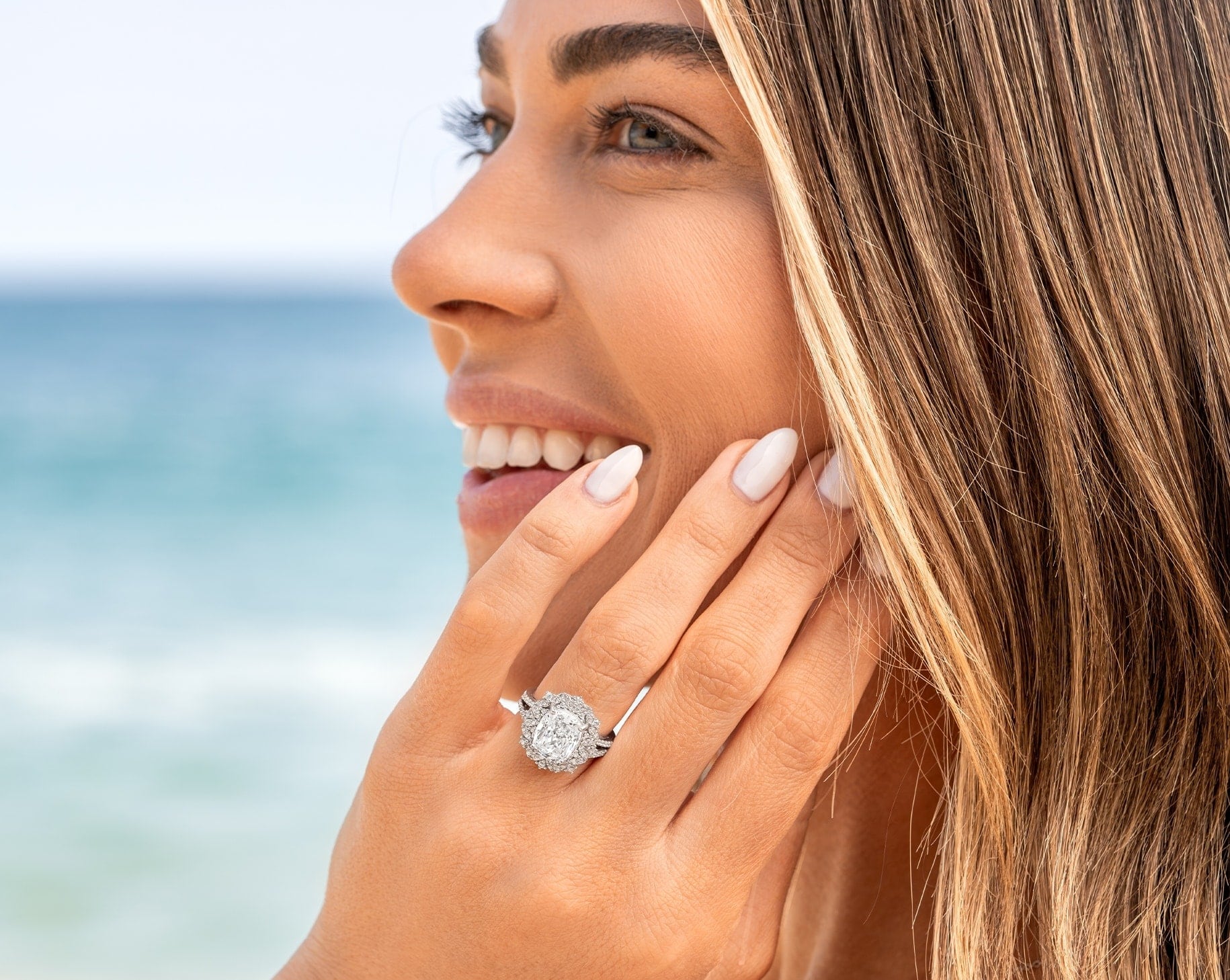 woman wearing vintage engagement ring by ocean