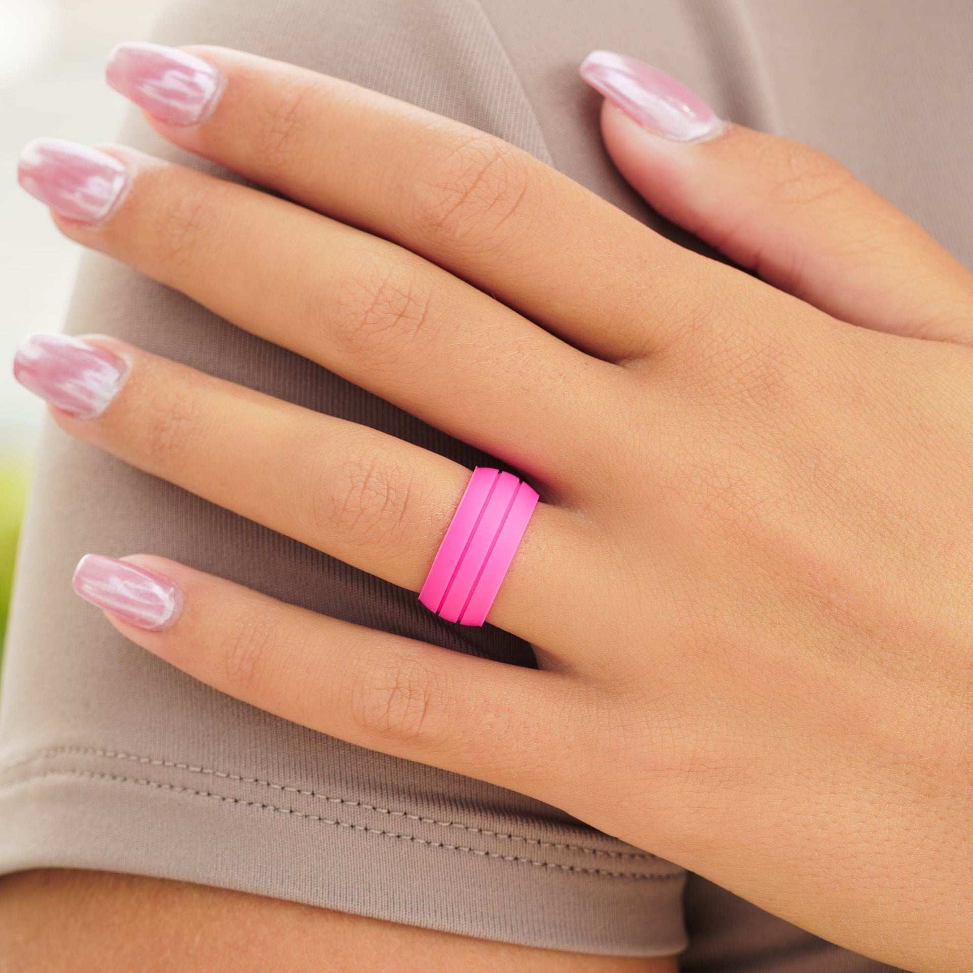 pink silicone wedding band on woman's hand