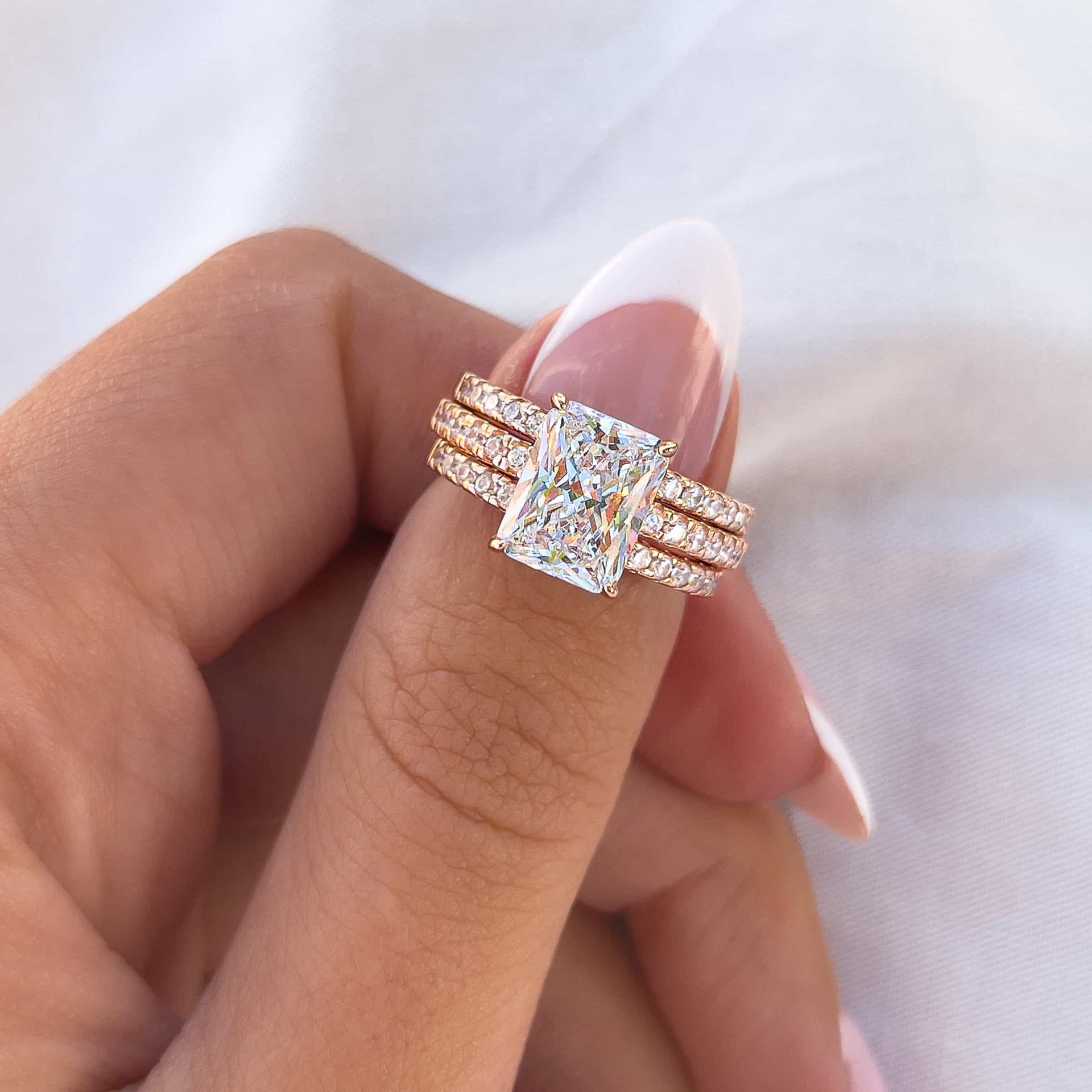 gorgeous radiant cut wedding ring stack shown in rose gold
