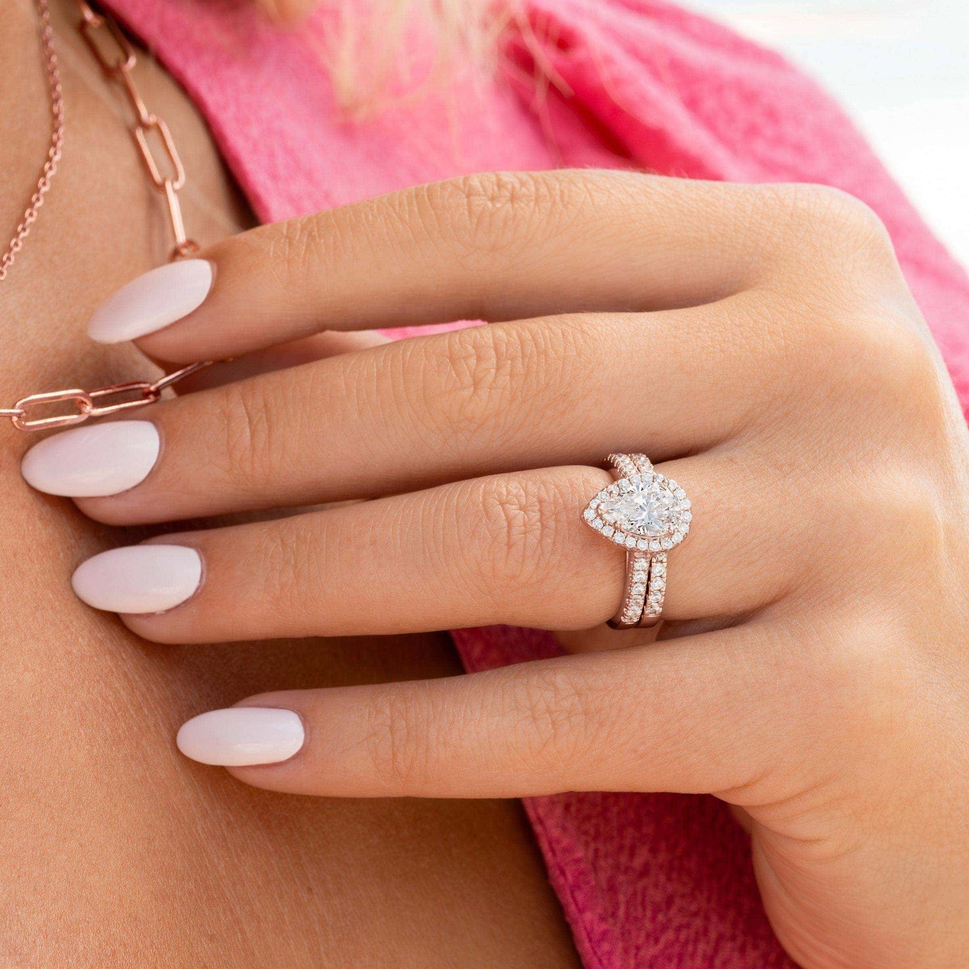 girl wearing pear shaped engagement ring with pink shirt