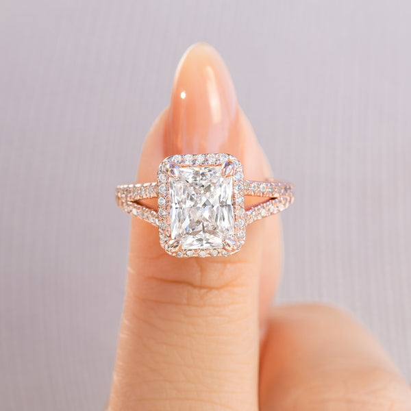 stunning rose gold radiant cut engagement ring with unique split shank detailing on female hand