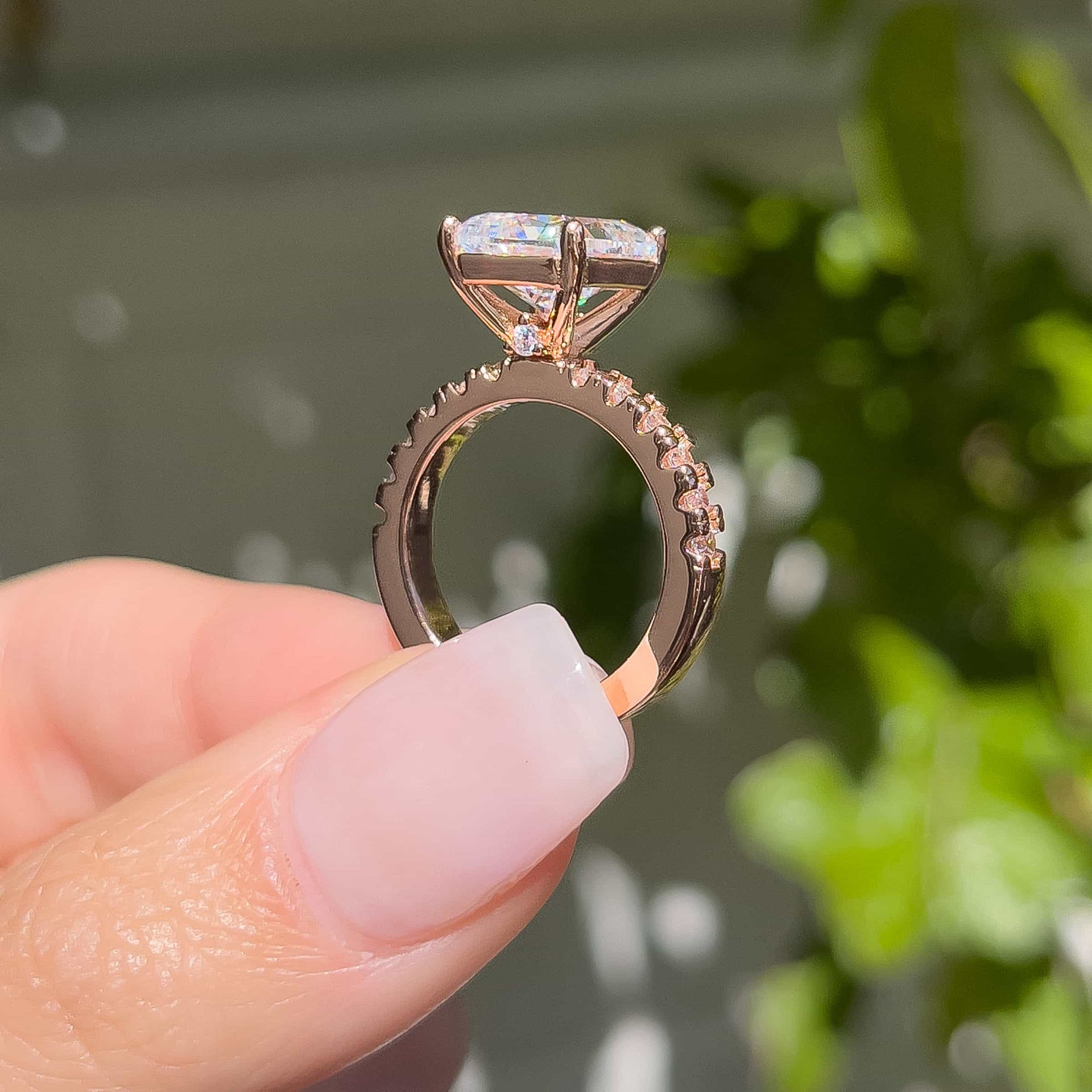 3.75 carat rose gold engagement ring setting shot shown in silver modeled on female with light pink nails and green background