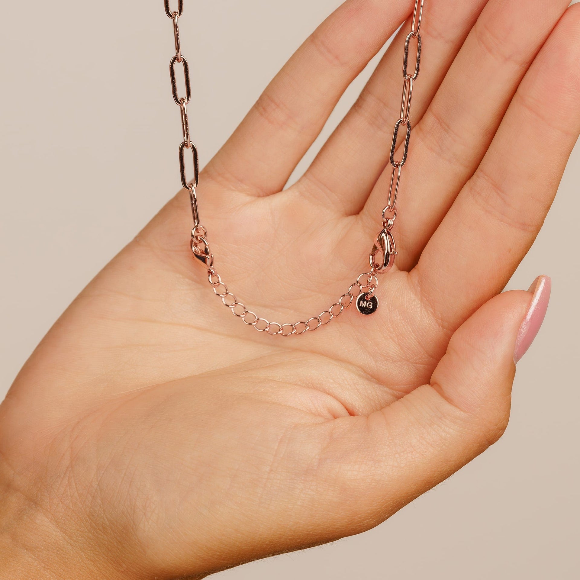 rose gold chain extender on palm of hand