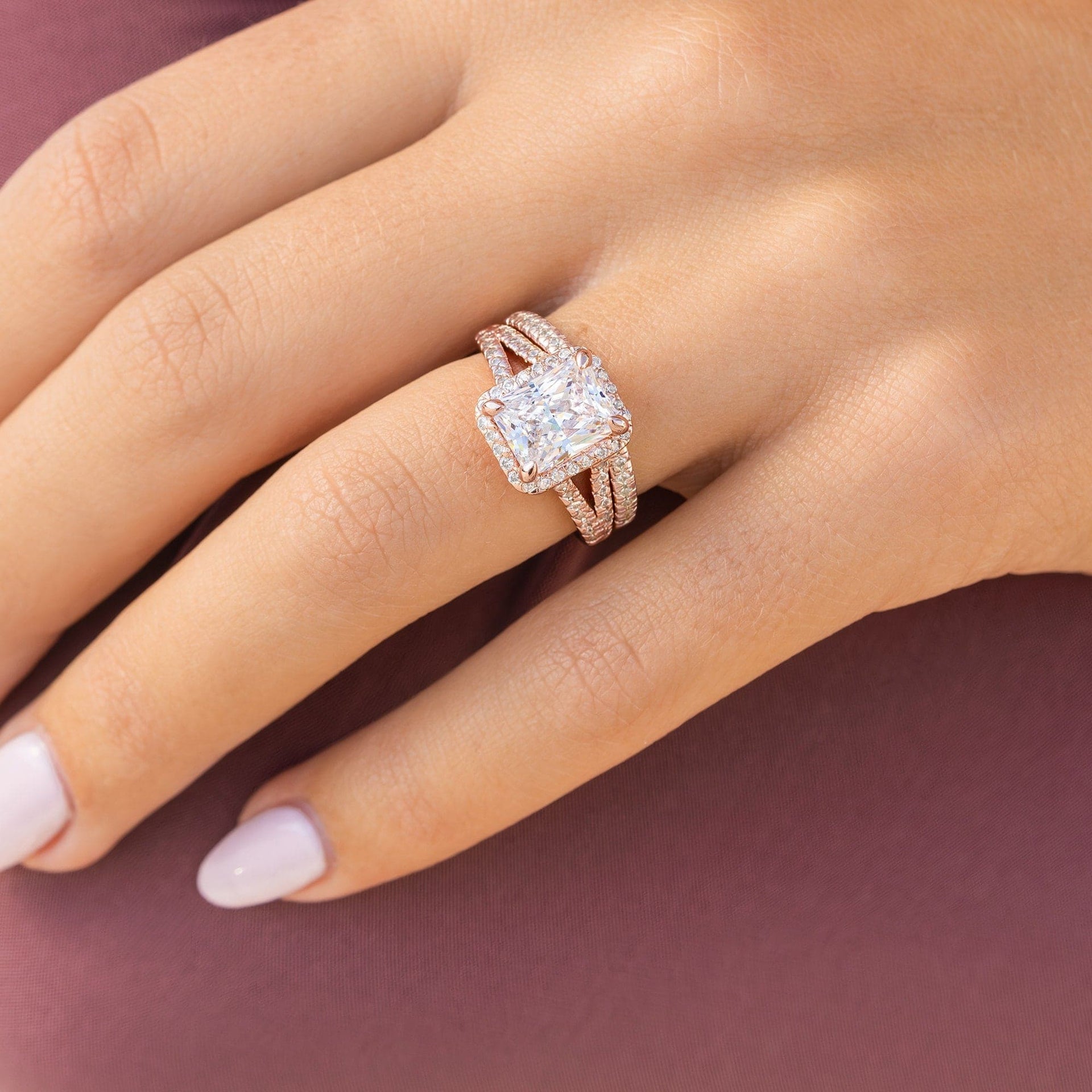 classic rose gold 3.5 carat radiant cut wedding ring set on female model
